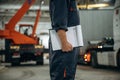 Documents in notepad. Male worker is in the modern warehouse or manufacturing company Royalty Free Stock Photo