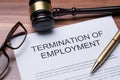 Documents About Termination Of Employment Over Wooden Desk