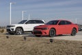 Dodge Charger and Jeep Grand Cherokee dealership display. Dodge and Jeep are part of the Stellantis family of cars and SUVs