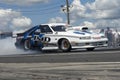 Dodge drag car making a smoke show on the track Royalty Free Stock Photo