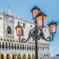 Street lamp with pink glasses - symbol of Venice and the Doge`s Palace in St. Mark`s Square, Venice, Italy. Royalty Free Stock Photo