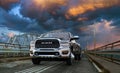 Dodge Ram 2500 on the old bridge during an evening storm Royalty Free Stock Photo