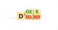 Doer or dreamer symbol. Concept words Doer or dreamer on wooden cubes. Beautiful white table white background. Business and doer