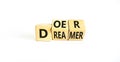 Doer or dreamer symbol. Concept words Doer or dreamer on wooden cubes. Beautiful white table white background. Business and doer