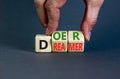 Doer or dreamer symbol. Concept words Doer or dreamer on wooden cubes. Businessman hand. Beautiful grey table grey background. Royalty Free Stock Photo