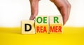 Doer or dreamer symbol. Concept words Doer or dreamer on wooden cubes. Businessman hand. Beautiful yellow table white background.