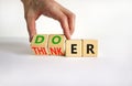 Doer or thinker symbol. Concept words Doer or thinker on wooden cubes. Businessman hand. Beautiful white table white background.