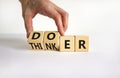 Doer or thinker symbol. Concept words Doer or thinker on wooden cubes. Businessman hand. Beautiful white table white background.