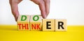 Doer or thinker symbol. Concept words Doer or thinker on wooden cubes. Businessman hand. Beautiful yellow table white background.