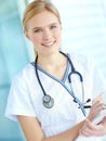 She does everything to make your medical stay more comfortable. Portrait of a smiling nurse writing notes in her notepad Royalty Free Stock Photo