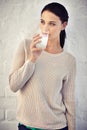 It does her body good. Shot of a young woman drinking a glass of milk. Royalty Free Stock Photo
