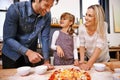 Does this look ok dad. A family making pizza together at home. Royalty Free Stock Photo