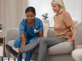 Does the pain feel worse when you flex your ankle. a doctor examining a senior womans ankle on the sofa at home.