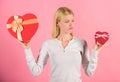 Does size really matter. Woman hold big and little heart shaped gift boxes. Which one she prefer. Girl decide which gift