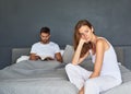 He doesnt even care. a young couple having marital problems in the bedroom at home. Royalty Free Stock Photo