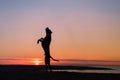 Dog on the beach. Active pit bull terrier jumping on the background of the sea