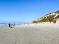 Dog Beach off-leash on Del Mar North Beach, people walking their dogs. San Diego County Royalty Free Stock Photo