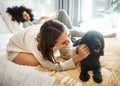 Dog, bedroom and lesbian couple playing in home, morning and relax together in house. Pet, bed and gay women with animal Royalty Free Stock Photo