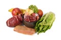 Dog bowl filled with biologically appropriate raw food containing meat chunks, fish, fruits and vegetables