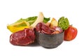 Dog bowl filled with biologically appropriate raw food containing meat chunks, fruits and vegetables