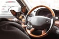 Dog in the car in the hands of the driver. A miniature pinscher travels with its owner. Pet driving a car