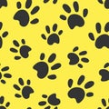 Dog or cat paws traces illustration. Grey stamps on yellow background. Seamless pattern. For logo, wallpaper, fabric, packing,