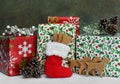 Dog cookies for Christmas in a stocking in front of wrapped gifts Royalty Free Stock Photo