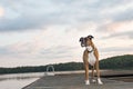 Dog on dock at sunrise