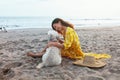 Dog-Friendly Beach. Woman In Boho Dress And Straw Hat With Cute Dog On Sandy Coast