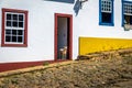 Dog in front of colorful colonial houses and cobblestone street - Tiradentes, Minas Gerais, Brazil Royalty Free Stock Photo