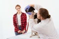 Dog getting checked at vet clinic with thir owner. Royalty Free Stock Photo