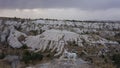 Dog in hills and view on valley with white rocks in stormy weather, Cappadoccia