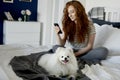 Dog and his female owner on the bed Royalty Free Stock Photo