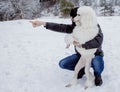 The dog and its owner looking into the distance in winter