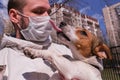 Dog Jack Russell in the arms of a man, its owner