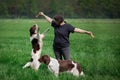 Dog jumps up to catch chew bone from owner