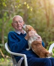 Dog kissing old man in garden Royalty Free Stock Photo