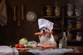Dog in the kitchen with vegetables. Nutrition for animals, natural food. Border Collie in a Cooking Hat Royalty Free Stock Photo
