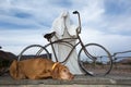 Dog laying at a ghost statue