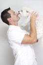 Dog licking nose of man