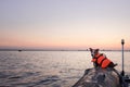 Dog in a life jacket in a boat. Jack Russell Terrier sea voyage