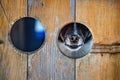 Dog looking through a hole in the fence Royalty Free Stock Photo