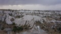 Dog looking at valley with white rocks in stormy weather, Cappadoccia