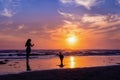 Dog with owner running on the beach Royalty Free Stock Photo