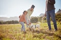 Dog, park and pet family with child, mother and father in nature or a grass field for outdoor wellness. Bonding, love Royalty Free Stock Photo