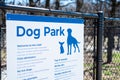 Dog park sign with rules policies on galvanized vinyl-coated chain link fences, steel posts and panels at rest area public picnic