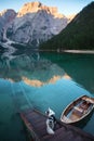 Dog on a pier on Lake braies, Italy. Marble Austrian Shepherd in nature. Royalty Free Stock Photo