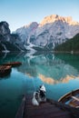 Dog on a pier on Lake braies, Italy. Marble Austrian Shepherd in nature. Royalty Free Stock Photo