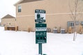 Dog poop bags dispenser for dog waste in a snowy neighborhood in winter