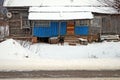 The dog protects the rural house standing at a porch. Rural life in the winter. Royalty Free Stock Photo